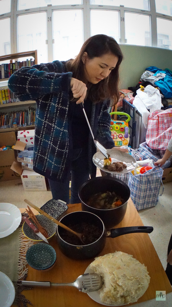 Smyth serves up a freshly cooked meal at the Refugee Union (photo credit: Matt Haslam)